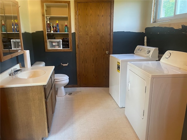 laundry area featuring independent washer and dryer and sink