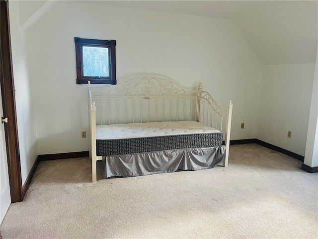 carpeted bedroom featuring lofted ceiling