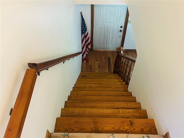 staircase featuring hardwood / wood-style flooring