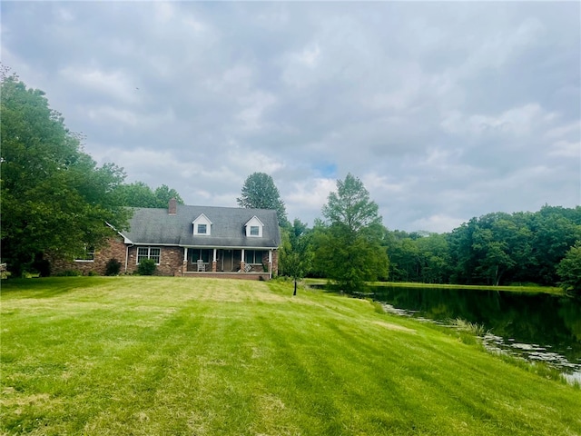 exterior space featuring a water view and a lawn