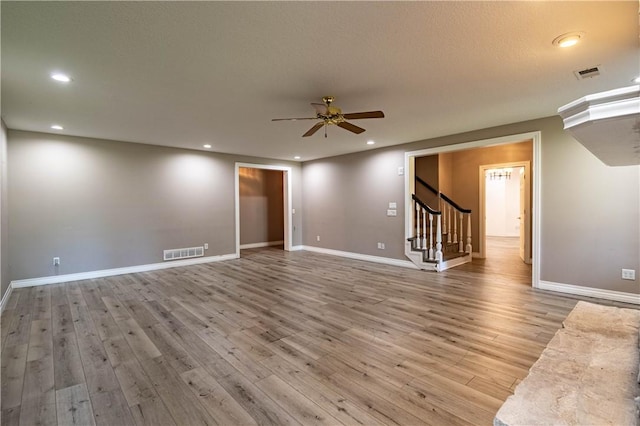 1250 W Hickory Point Rd, Decatur, IL 62526 - empty room with ceiling fan, stairway, wood finished floors, and recessed lighting