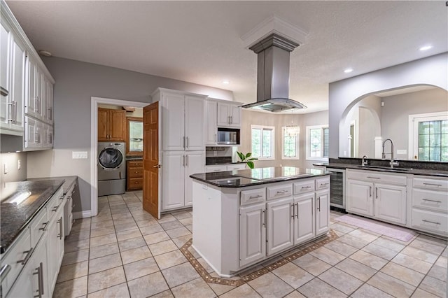 1250 W Hickory Point Rd, Decatur, IL 62526 - kitchen with washer / clothes dryer, beverage cooler, a kitchen island, light tile patterned floors, and recessed lighting