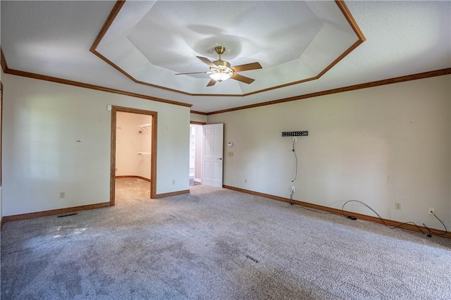 1250 W Hickory Point Rd, Decatur, IL 62526 - carpeted spare room with a raised ceiling, a ceiling fan, and crown molding