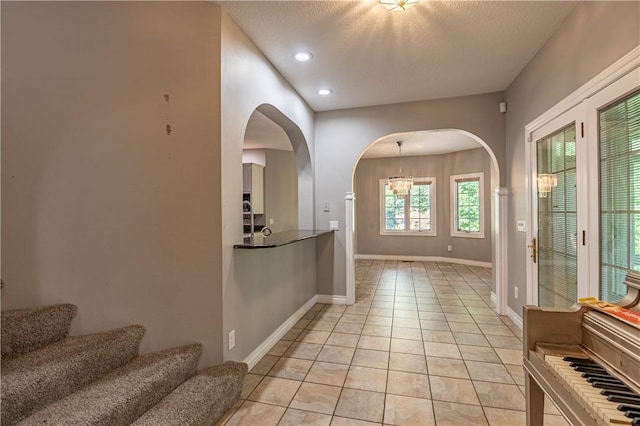1250 W Hickory Point Rd, Decatur, IL 62526 - entrance foyer featuring arched walkways, light tile patterned floors, recessed lighting, a textured ceiling, and stairway