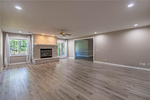 1250 W Hickory Point Rd, Decatur, IL 62526 - unfurnished living room with a ceiling fan, plenty of natural light, a fireplace, wood finished floors, and recessed lighting