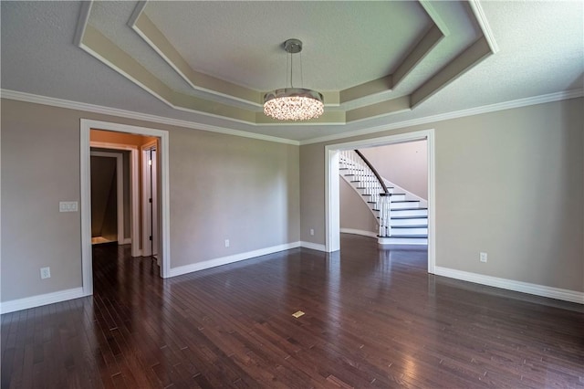 1250 W Hickory Point Rd, Decatur, IL 62526 - empty room featuring a raised ceiling, a chandelier, stairs, wood finished floors, and crown molding
