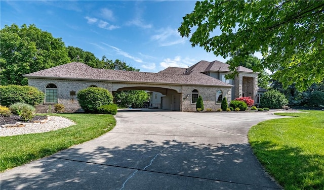 1250 W Hickory Point Rd, Decatur, IL 62526 - french country inspired facade with brick siding, a front lawn, and concrete driveway