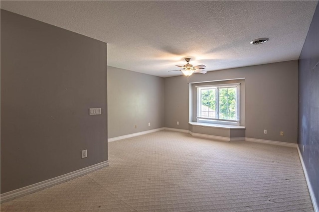 1250 W Hickory Point Rd, Decatur, IL 62526 - unfurnished room with light carpet, a ceiling fan, and a textured ceiling