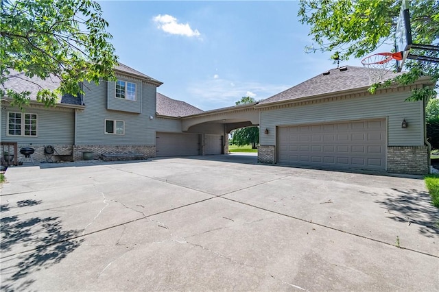 1250 W Hickory Point Rd, Decatur, IL 62526 - view of front of house featuring brick siding, driveway, an attached garage, and a shingled roof