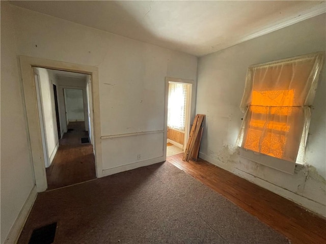 spare room featuring visible vents and wood finished floors