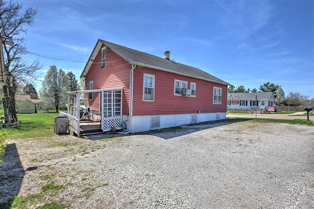 view of home's exterior featuring gravel driveway