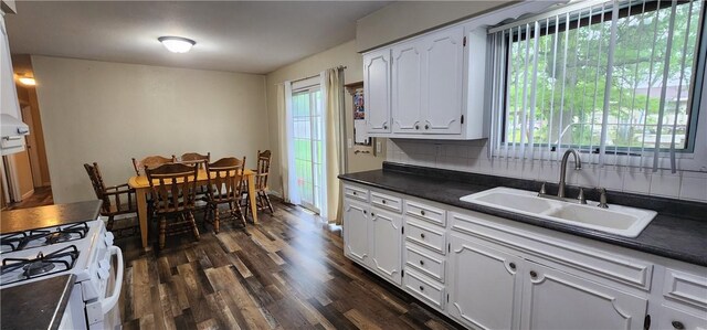 22 S Lakewood Dr, Effingham, IL 62401 - kitchen with dark countertops, a sink, white cabinetry, dark wood-style flooring, and white gas stove