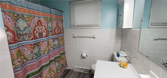 22 S Lakewood Dr, Effingham, IL 62401 - full bath featuring tile walls, toilet, a wainscoted wall, wood finished floors, and a shower with curtain