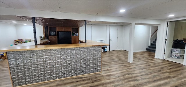 22 S Lakewood Dr, Effingham, IL 62401 - finished basement with freestanding refrigerator, stairs, wood finished floors, a bar, and recessed lighting