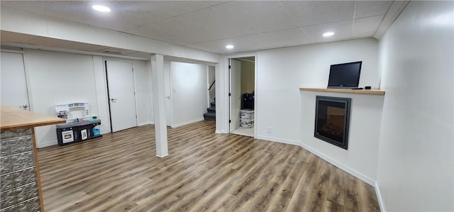 22 S Lakewood Dr, Effingham, IL 62401 - finished basement featuring stairs, wood finished floors, a glass covered fireplace, baseboards, and recessed lighting
