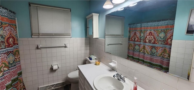 22 S Lakewood Dr, Effingham, IL 62401 - full bathroom with tile walls, toilet, wainscoting, vanity, and a shower with shower curtain