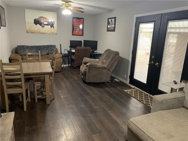 201 Franklin St, Pana, IL 62557 - living area featuring dark wood-type flooring, baseboards, ceiling fan, french doors, and a textured ceiling