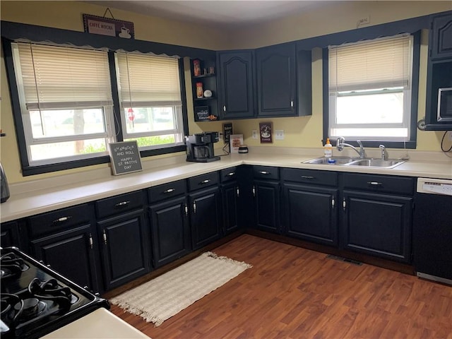 201 Franklin St, Pana, IL 62557 - kitchen featuring dark wood finished floors, dishwasher, light countertops, and a sink