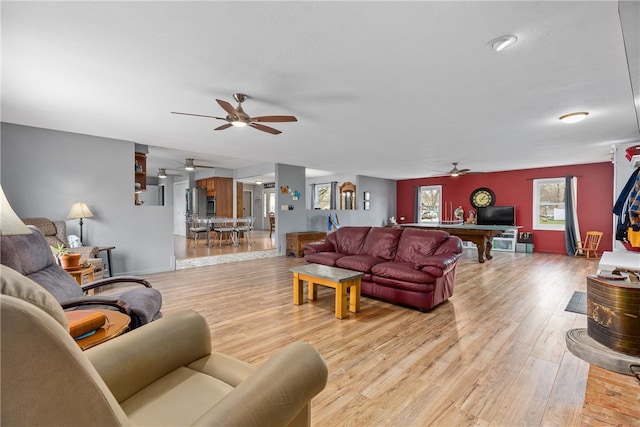 living room featuring light hardwood / wood-style flooring, ceiling fan, and billiards