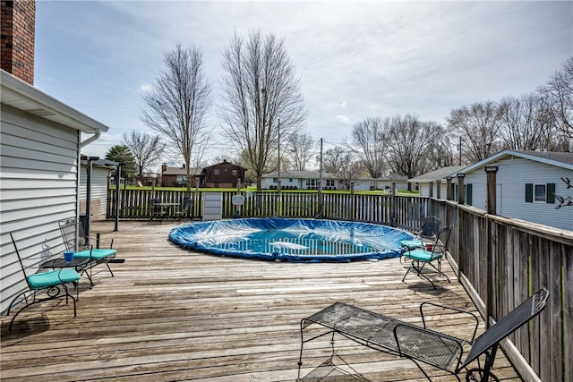 wooden terrace featuring a covered pool