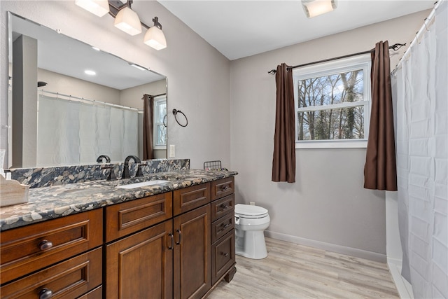 bathroom with vanity, wood-type flooring, and toilet