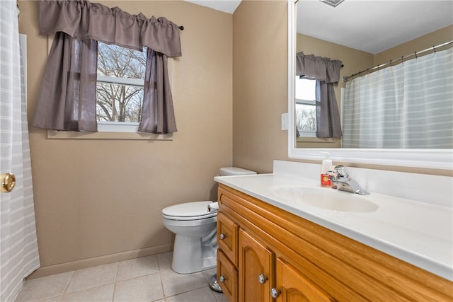 bathroom featuring tile patterned floors, vanity, and toilet