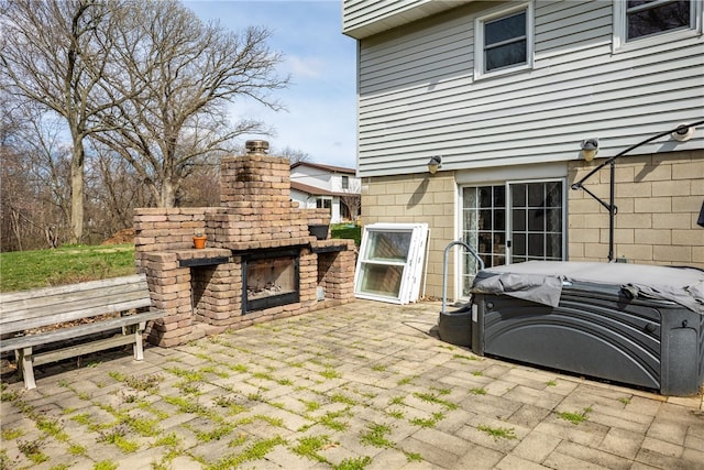 view of patio featuring an outdoor brick fireplace