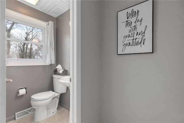 bathroom with tile patterned flooring and toilet