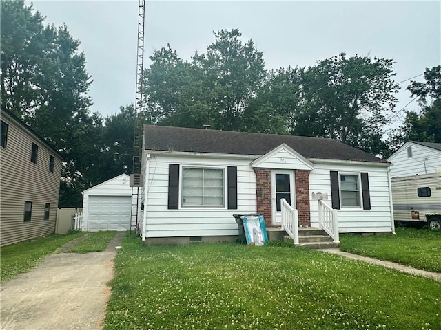 625 Woodlawn Ave, Mattoon, IL 61938 - bungalow-style home featuring a detached garage, an outbuilding, a front yard, concrete driveway, and crawl space