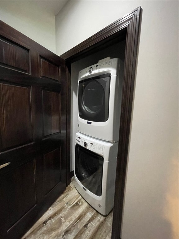 104 Woodland Dr, Marshall, IL 62441 - laundry area featuring stacked washer and clothes dryer and light wood-type flooring