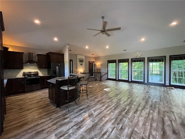 104 Woodland Dr, Marshall, IL 62441 - kitchen featuring wall chimney range hood, black refrigerator with ice dispenser, a wealth of natural light, and stainless steel electric range