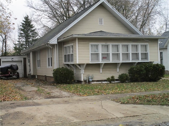 view of home's exterior featuring a garage and an outdoor structure