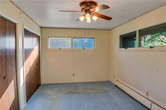 27 Heather Dr, Charleston, IL 61920 - unfurnished bedroom featuring a baseboard heating unit, carpet floors, multiple closets, ceiling fan, and baseboards