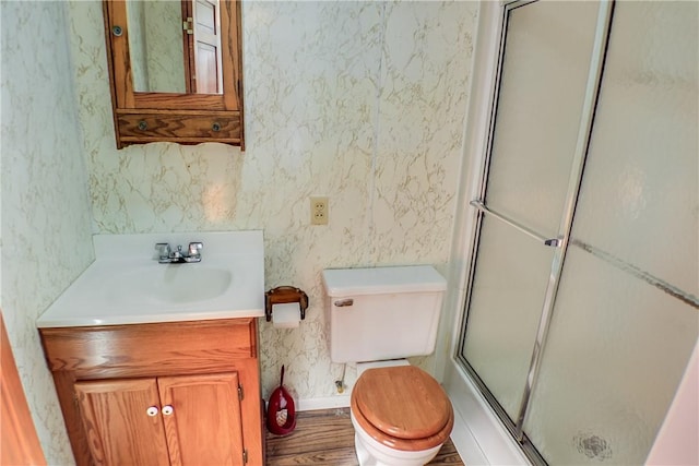 27 Heather Dr, Charleston, IL 61920 - bathroom with toilet, vanity, a shower with door, wood finished floors, and baseboards