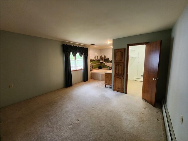 2638 E 1050th Ave, Oblong, IL 62449 - unfurnished bedroom with baseboard heating and light carpet