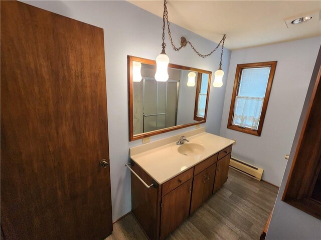 2638 E 1050th Ave, Oblong, IL 62449 - bathroom with baseboard heating, wood finished floors, and vanity