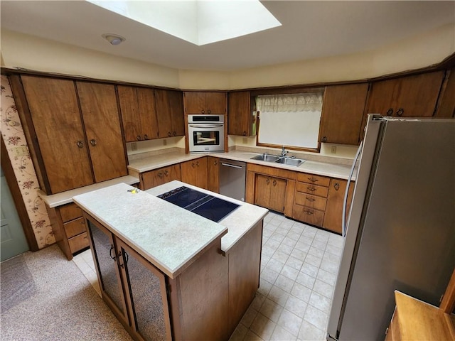 2638 E 1050th Ave, Oblong, IL 62449 - kitchen with appliances with stainless steel finishes, a sink, a center island, light countertops, and a skylight
