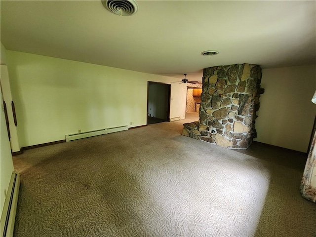2638 E 1050th Ave, Oblong, IL 62449 - unfurnished living room with a baseboard radiator, a ceiling fan, carpet flooring, and a stone fireplace