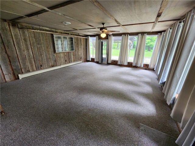 2638 E 1050th Ave, Oblong, IL 62449 - spare room with baseboard heating, a ceiling fan, and wood walls