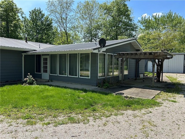 2638 E 1050th Ave, Oblong, IL 62449 - rear view of property featuring a sunroom, metal roof, and a patio