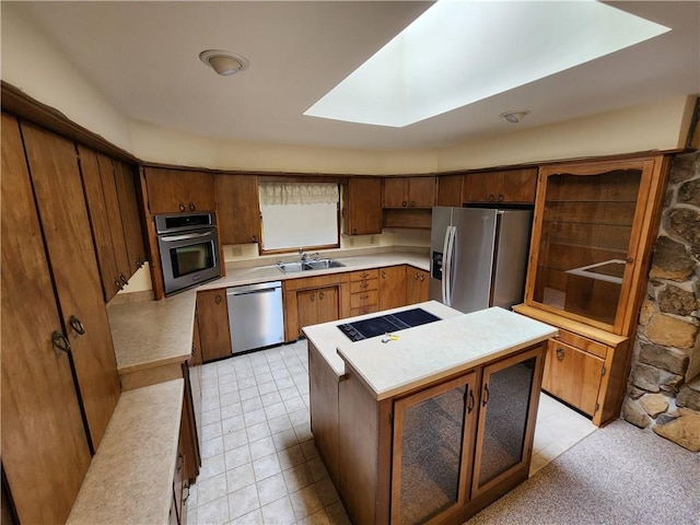 2638 E 1050th Ave, Oblong, IL 62449 - kitchen with stainless steel appliances, a sink, light countertops, a kitchen island, and a skylight