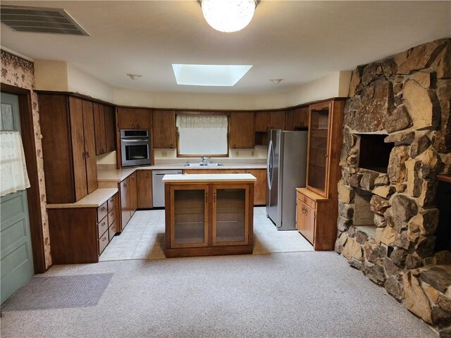 2638 E 1050th Ave, Oblong, IL 62449 - kitchen with appliances with stainless steel finishes, a skylight, light countertops, and light colored carpet