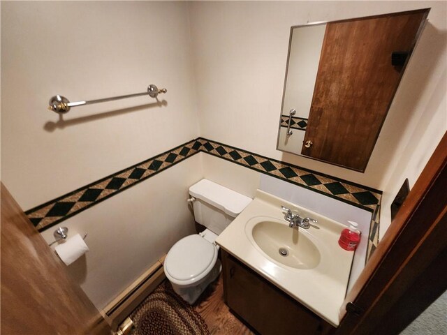 2638 E 1050th Ave, Oblong, IL 62449 - half bath featuring a baseboard heating unit, toilet, vanity, and tile walls