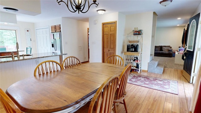 dining area with an inviting chandelier, recessed lighting, and light wood-type flooring