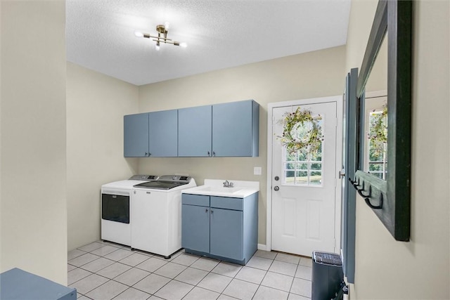 715 W Coolidge Ave, Charleston, IL 61920 - washroom with cabinet space, washer and dryer, light tile patterned floors, and a textured ceiling