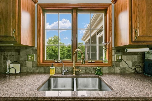 715 W Coolidge Ave, Charleston, IL 61920 - kitchen with tasteful backsplash, healthy amount of natural light, and brown cabinetry