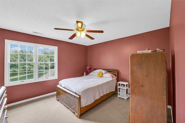 715 W Coolidge Ave, Charleston, IL 61920 - bedroom featuring carpet flooring, a textured ceiling, and ceiling fan