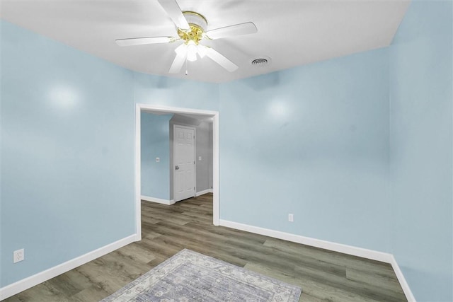 715 W Coolidge Ave, Charleston, IL 61920 - empty room with wood finished floors and a ceiling fan