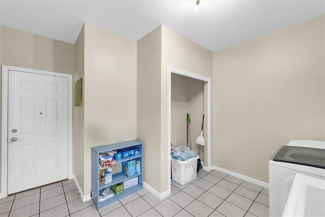 715 W Coolidge Ave, Charleston, IL 61920 - laundry area with light tile patterned flooring and a textured ceiling