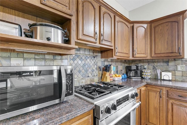 715 W Coolidge Ave, Charleston, IL 61920 - kitchen with stainless steel appliances, brown cabinets, and backsplash